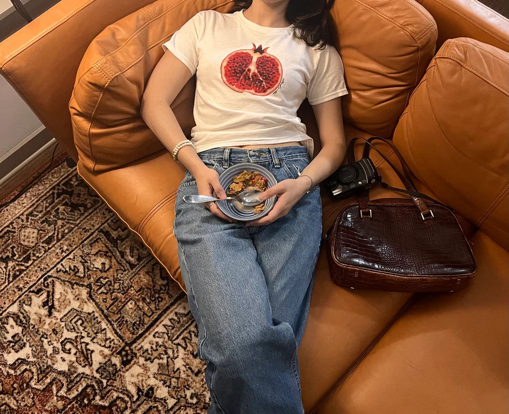 white-pomegranate-baby-tee-women-model-on-sofa.jpg
